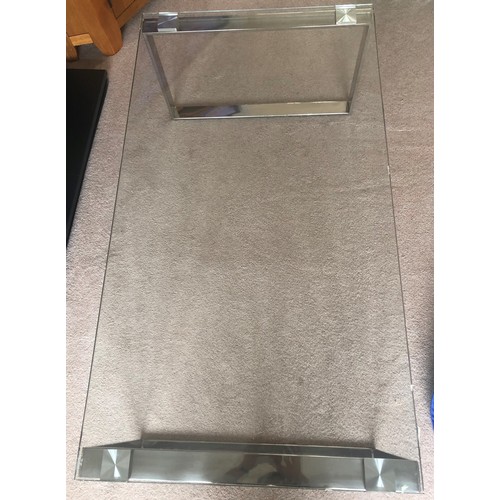 3433 - A glass rectangular topped coffee table on chrome supports, 110cm long, 60cm wide, 39cm high.