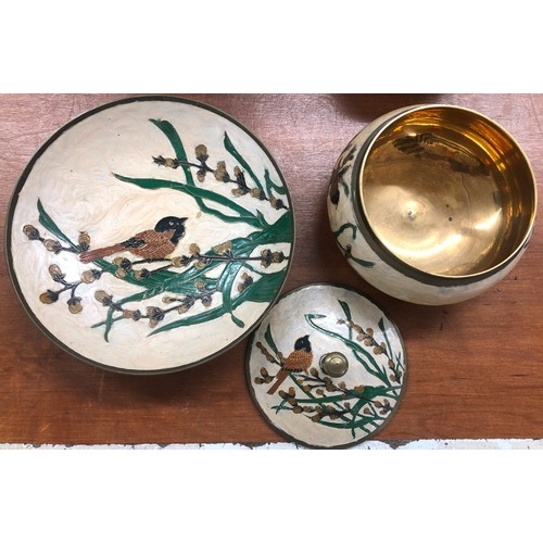 3553 - A painted brass dish and pot with lid on cream ground with bird and tree decoration, dish 23cm diame... 