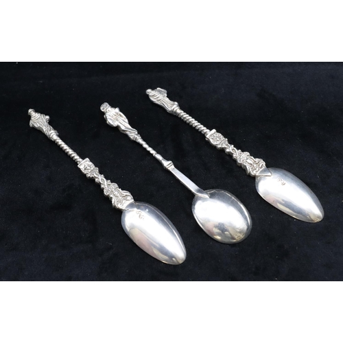 308 - A pair of Continental silver coloured metal Apostle teaspoons with twist stems and a similar smaller... 