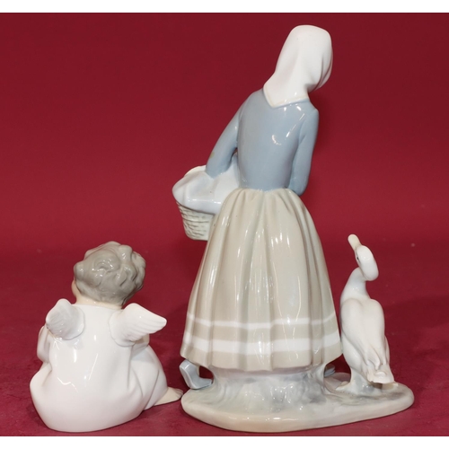 58 - A Lladro figure of a standing lady with duck at her feet (2 fingers missing), 23cm high and a Lladro... 