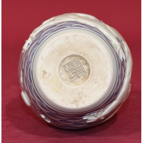 62 - An Oriental round bulbous thin necked vase on blue and white ground with raised dragon decoration, 2... 