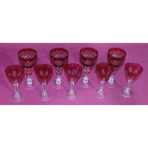 140 - A set of 4 ruby and clear wine glasses with thumb pattern decoration, 18cm high and a set of 5 ruby ... 