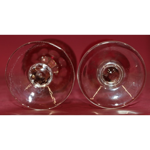 140 - A set of 4 ruby and clear wine glasses with thumb pattern decoration, 18cm high and a set of 5 ruby ... 