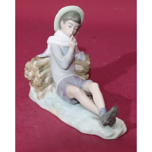 57 - A Lladro figure of a relaxing young boy, 21cm long