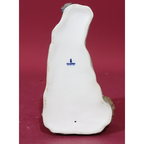 57 - A Lladro figure of a relaxing young boy, 21cm long