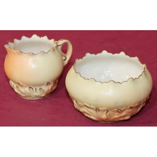 66 - A Locke & Co. Worcester cream jug and sugar bowl on cream ground with raised floral and leaf decorat... 