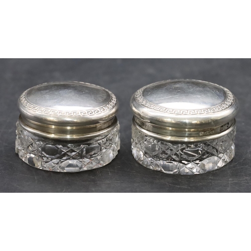 267 - 2 cut glass round small dressing table pots with Chester silver tops