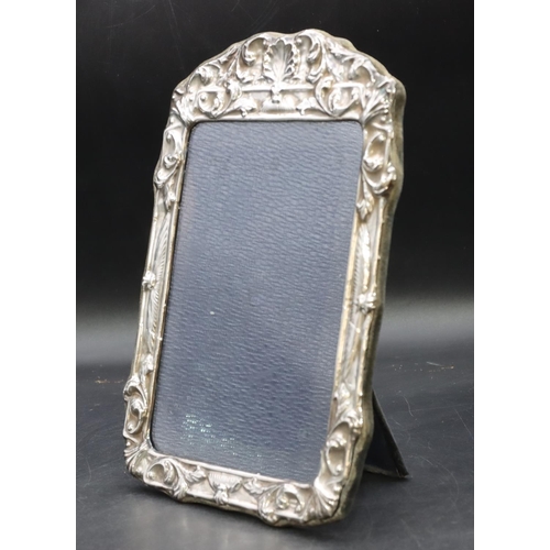 268 - A modern London silver mounted freestanding photograph frame with embossed shell and scroll rim, 24.... 