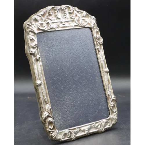 268 - A modern London silver mounted freestanding photograph frame with embossed shell and scroll rim, 24.... 