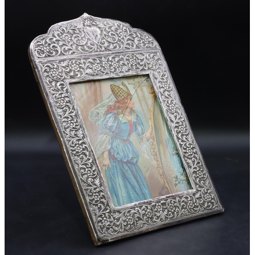 269 - A Continental silver coloured metal freestanding photograph frame with allover embossed floral, leaf... 