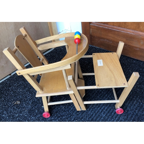 4011 - A wood toy highchair folding down to chair and table, 63cm high overall and a baby doll, 50cm long, ... 