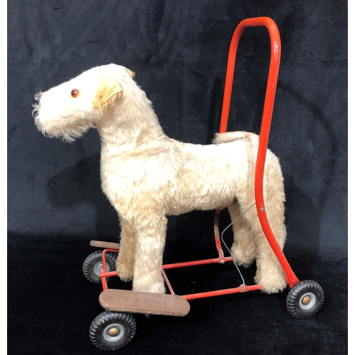 4043 - A child's Tri-Ang style vintage push-a-long dog, 49cm wide, 60cm high. (Fur to top worn)