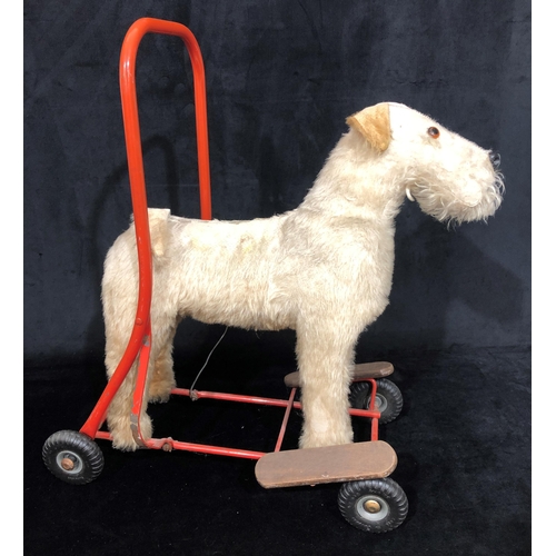 4043 - A child's Tri-Ang style vintage push-a-long dog, 49cm wide, 60cm high. (Fur to top worn)