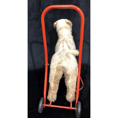 4043 - A child's Tri-Ang style vintage push-a-long dog, 49cm wide, 60cm high. (Fur to top worn)