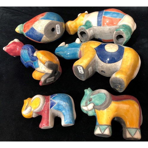 4055 - A collection of handmade South African animals with multi-coloured glaze, rhinoceros, 2 elephants, m... 