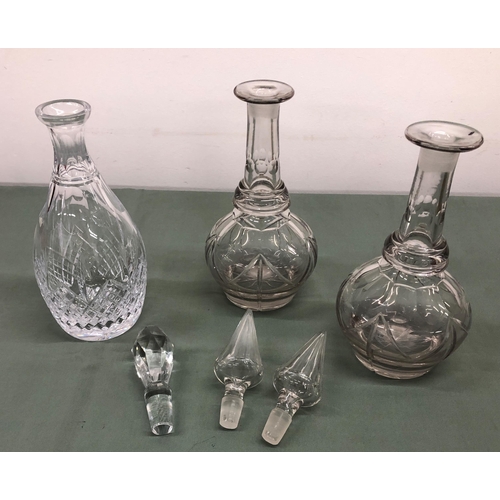 4058 - A pair of glass decanters, 34.5cm high overall (chips to tip of both stoppers) and 1 other decanter,... 