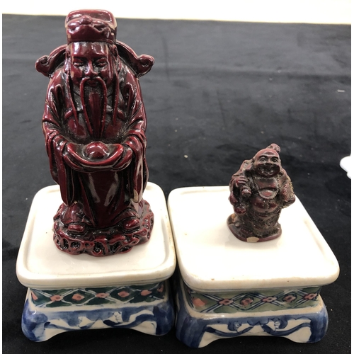 4091 - A pair of Chinese waving cats with detachable heads, 13cm high,  pair of Oriental stands, a bird and... 