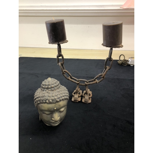 4093 - A metal Buddha's head, 17cm high (rust to back of head) and a metal double candle holder, 26.5cm hig... 