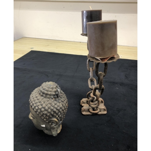 4093 - A metal Buddha's head, 17cm high (rust to back of head) and a metal double candle holder, 26.5cm hig... 