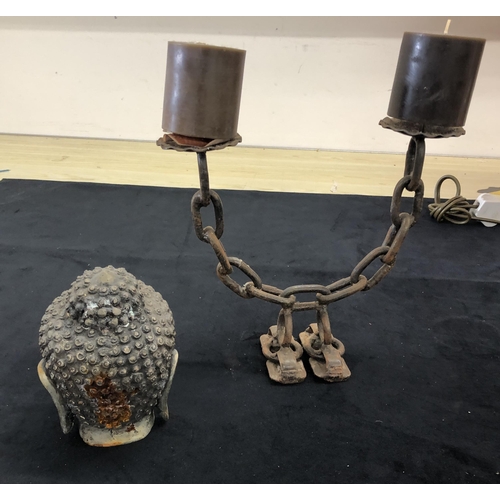 4093 - A metal Buddha's head, 17cm high (rust to back of head) and a metal double candle holder, 26.5cm hig... 