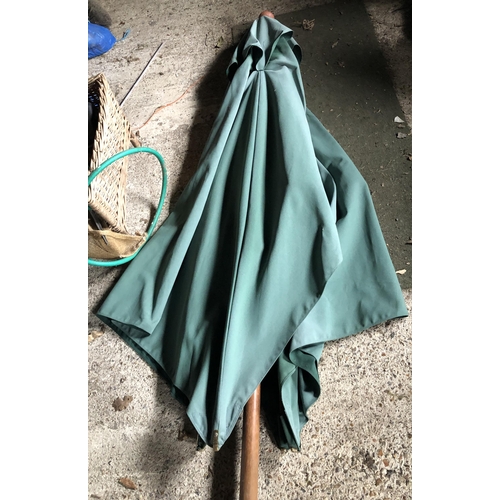 4104 - A green garden parasol with brass fittings, white cord and green fabric cover, (slightly weathered).... 