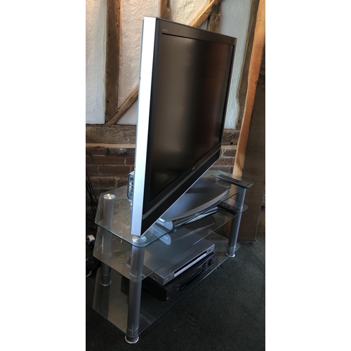 4108 - A large Sony flat screen TVA glass and chrome/metal TV stand, with 2 glass shelves and including , 1... 