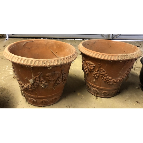 4113 - A pair of terracotta garden pots with shell and grape decoration to sides, 48cm diameter, 42.5cm hig... 