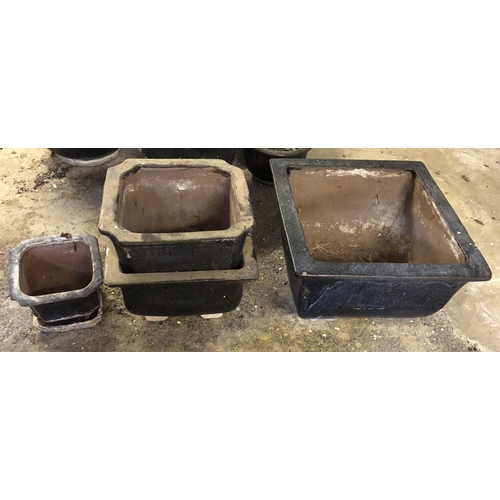 4116 - A pair of black glazed terracotta garden pots with square bases and 1 large and 1 small similar squa... 