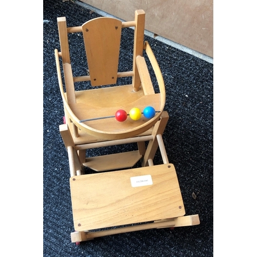 4011 - A wood toy highchair folding down to chair and table, 63cm high overall and a baby doll, 50cm long, ... 