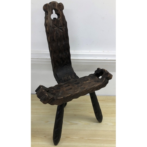 4015 - A carved wooden birthing chair on 3 splayed legs, 78cm high, 47cm wide