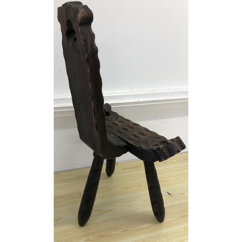 4015 - A carved wooden birthing chair on 3 splayed legs, 78cm high, 47cm wide