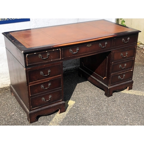 4030 - A reproduction mahogany knee hole double pedestal desk with brown leather inset top, centre drawer f... 