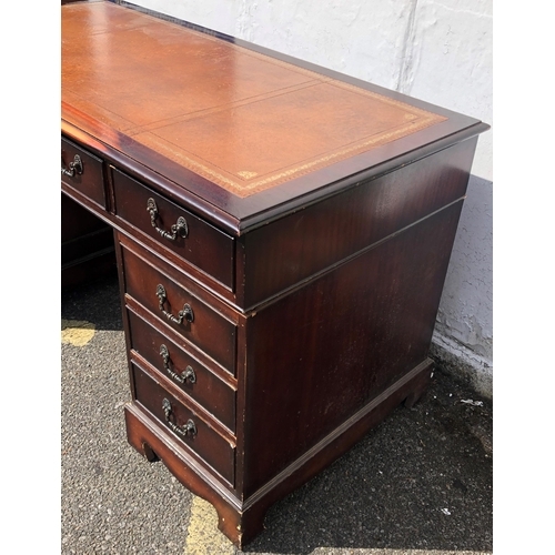 4030 - A reproduction mahogany knee hole double pedestal desk with brown leather inset top, centre drawer f... 