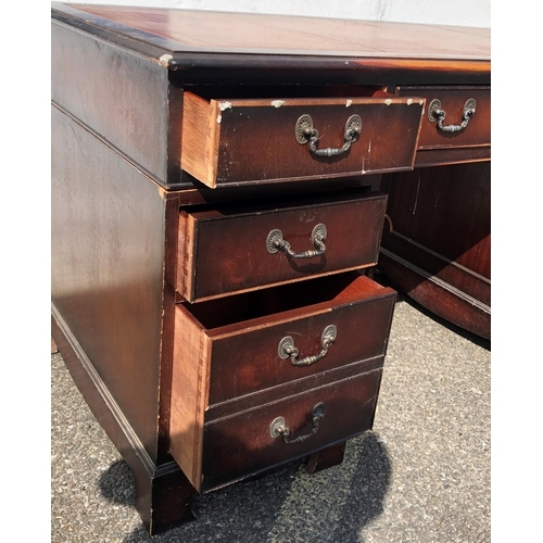 4030 - A reproduction mahogany knee hole double pedestal desk with brown leather inset top, centre drawer f... 