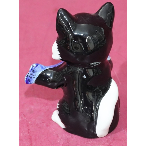 10 - A Lorna Bailey Art Deco style china figure of a seated cat holding a fish, 12.5cm high