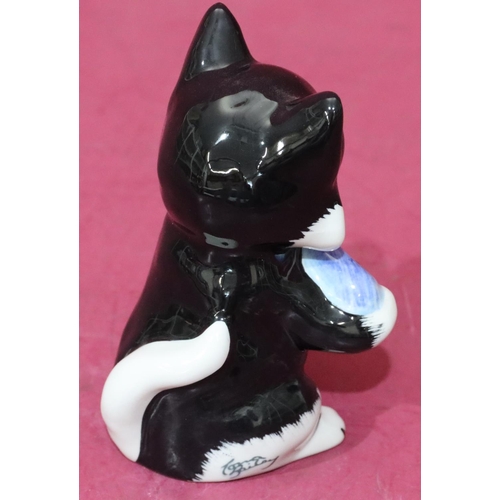 10 - A Lorna Bailey Art Deco style china figure of a seated cat holding a fish, 12.5cm high