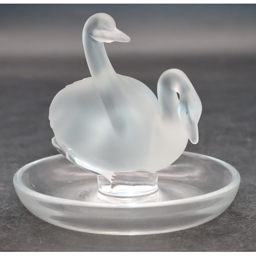 100 - A Lalique frosted glass ring dish with 2 swan motifs on round base, 10cm diameter, 9cm high