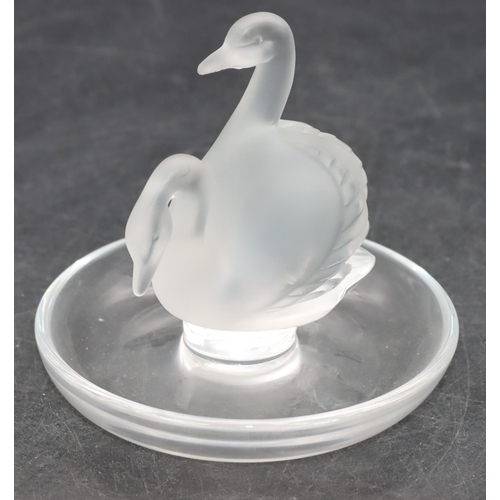 100 - A Lalique frosted glass ring dish with 2 swan motifs on round base, 10cm diameter, 9cm high