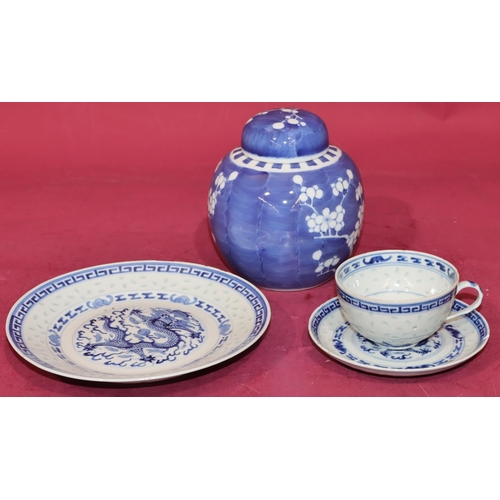 103 - An Oriental blue and white trio of cup, saucer and side plate with dragon decoration and a blue and ... 