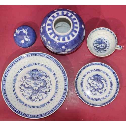 103 - An Oriental blue and white trio of cup, saucer and side plate with dragon decoration and a blue and ... 