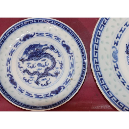 103 - An Oriental blue and white trio of cup, saucer and side plate with dragon decoration and a blue and ... 