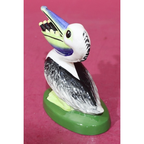 12 - A Lorna Bailey Art Deco style china figure of a pelican with bottles in its mouth, stamped to base 