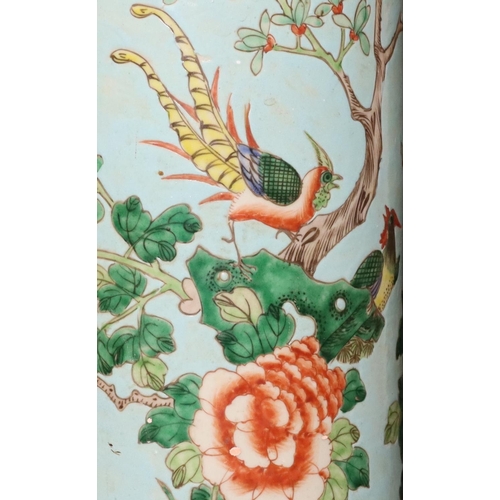 129 - A 19th/20th Century Chinese cylindrical umbrella stand on pale blue ground with multi-coloured bird,... 