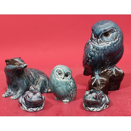 14 - A Poole china figure of a perched owl on blue and black ground, 18cm high, a Poole figure of a badge... 