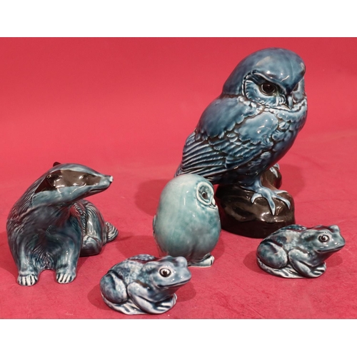 14 - A Poole china figure of a perched owl on blue and black ground, 18cm high, a Poole figure of a badge... 