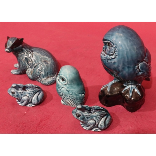 14 - A Poole china figure of a perched owl on blue and black ground, 18cm high, a Poole figure of a badge... 