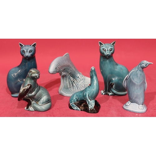 15 - A Poole figure of a leaping trout on blue ground, 12.5cm high, 2 Poole figures of seated cats on blu... 