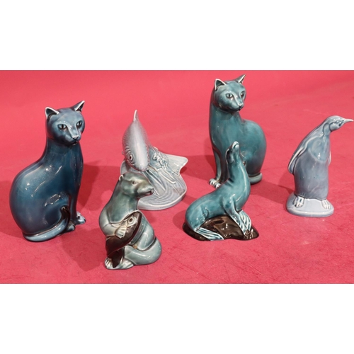 15 - A Poole figure of a leaping trout on blue ground, 12.5cm high, 2 Poole figures of seated cats on blu... 