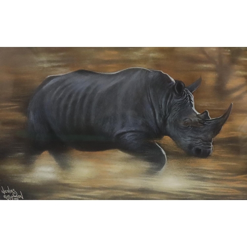 164 - Nicholas Ruston, pastel, depicting charging rhino, signed and dated '96, 20cm x 32cm, in gilt frame,