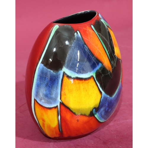 19 - A Poole oval bulbous shaped vase on vibrant red, blue, yellow and orange ground, 19cm high